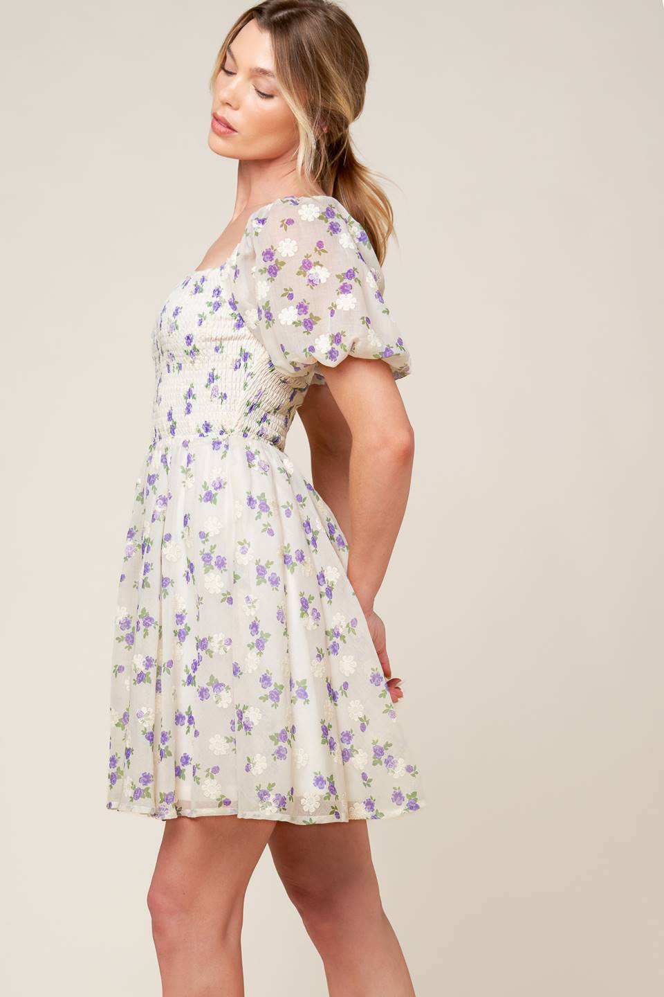 A floral texture printed woven mini dress featuring square neckline, short puff sleeve and full skirt.