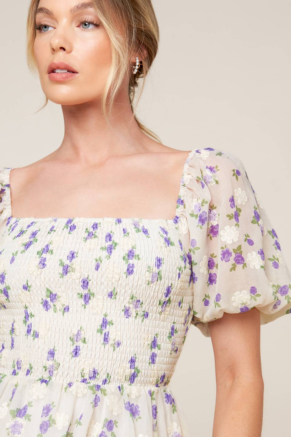 A floral texture printed woven mini dress featuring square neckline, short puff sleeve and full skirt.