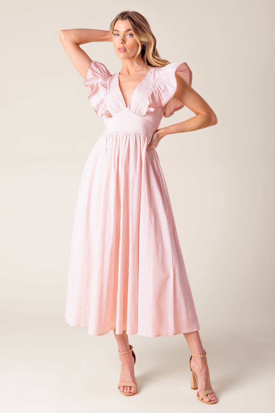 A pink and white striped woven midi dress featuring V neckline, ruffled sleeve, waist yoke, full skirt and bare back with tie detail.