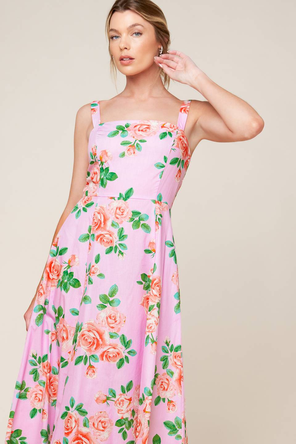 A pink floral printed woven midi dress featuring straight neckline, straps, circle skirt and back zipper closure.