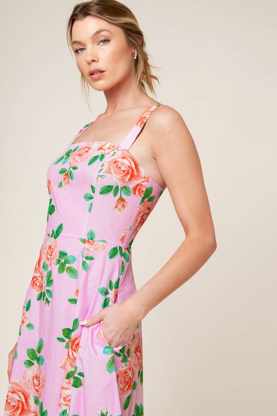 A pink floral printed woven midi dress featuring straight neckline, straps, circle skirt and back zipper closure.