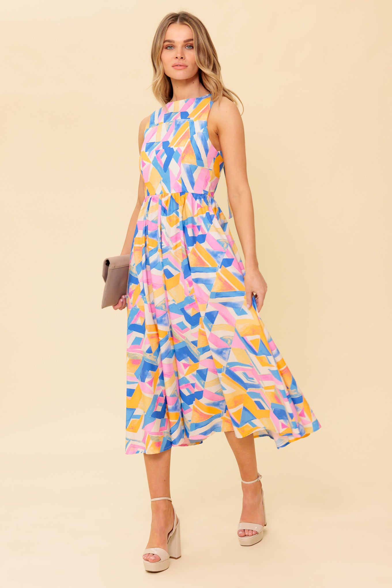 A printed woven midi dress featuring wide neckline, sleeveless, full skirt, bare back with tie and zipper closure