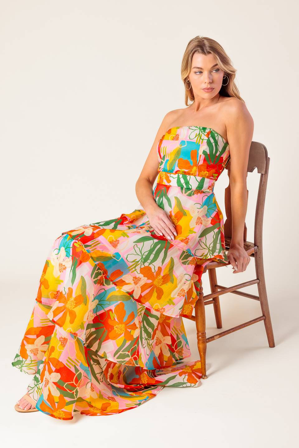 A printed woven maxi dress featuring strapless, layered skirt and back zipper closure