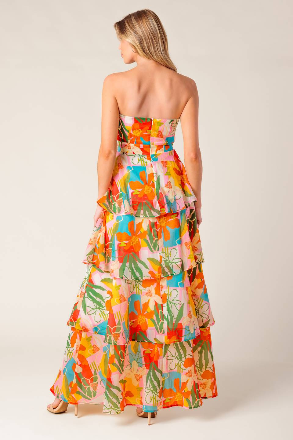 A printed woven maxi dress featuring strapless, layered skirt and back zipper closure