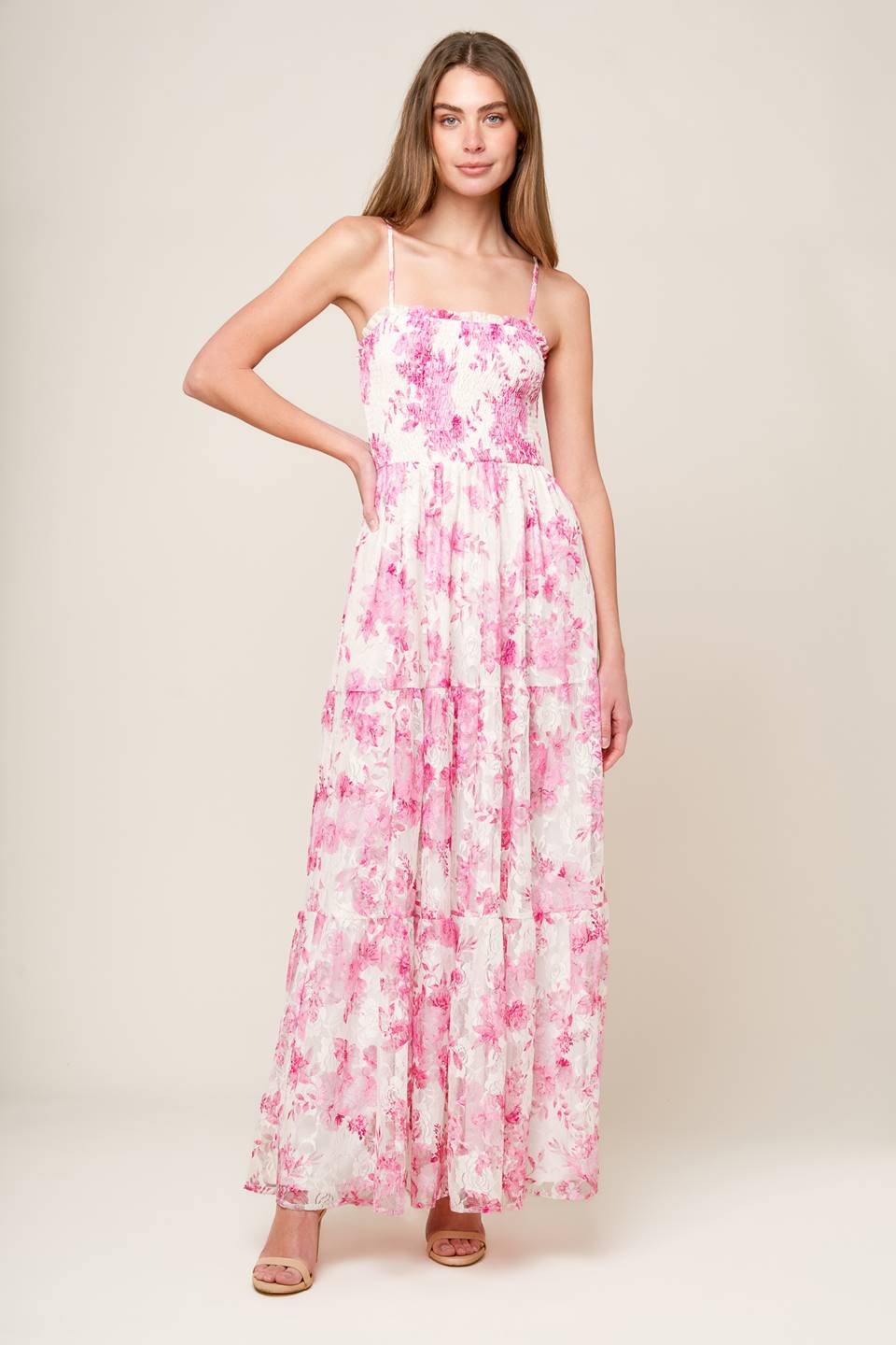 A pink and ivory, floral printed woven lace maxi dress featuring straight neckline with ruffled edge, straps, smocked bodice and tiered skirt.