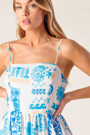 A printed woven midi dress featuring straight neckline, straps, full skirt and back zipper closure