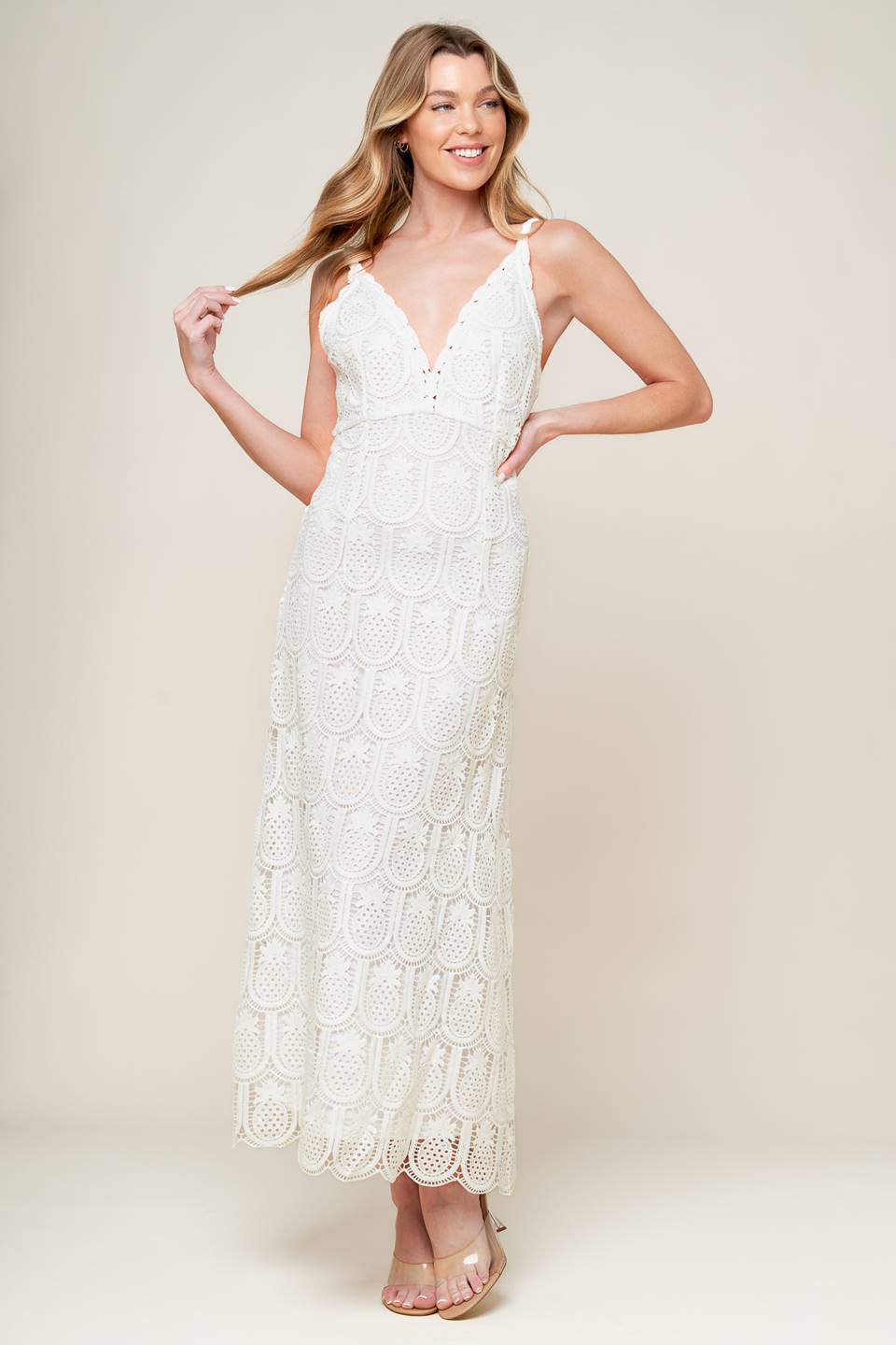 A white woven lace midi dress featuring lace trimmed V neckline and bare back with zipper closure.