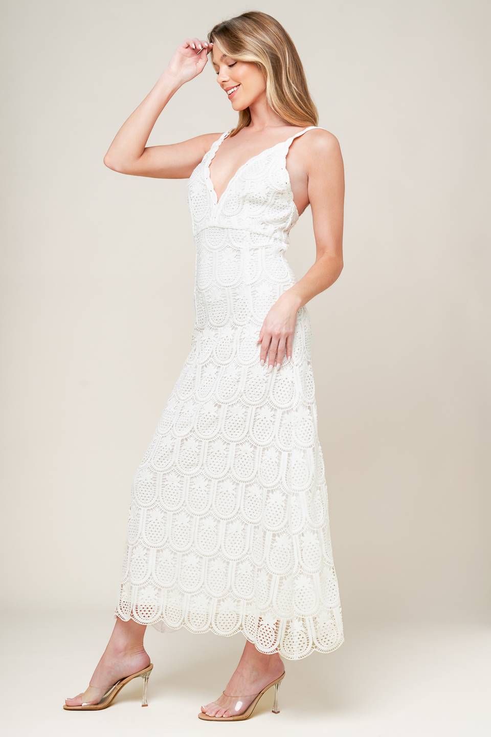 A white woven lace midi dress featuring lace trimmed V neckline and bare back with zipper closure.