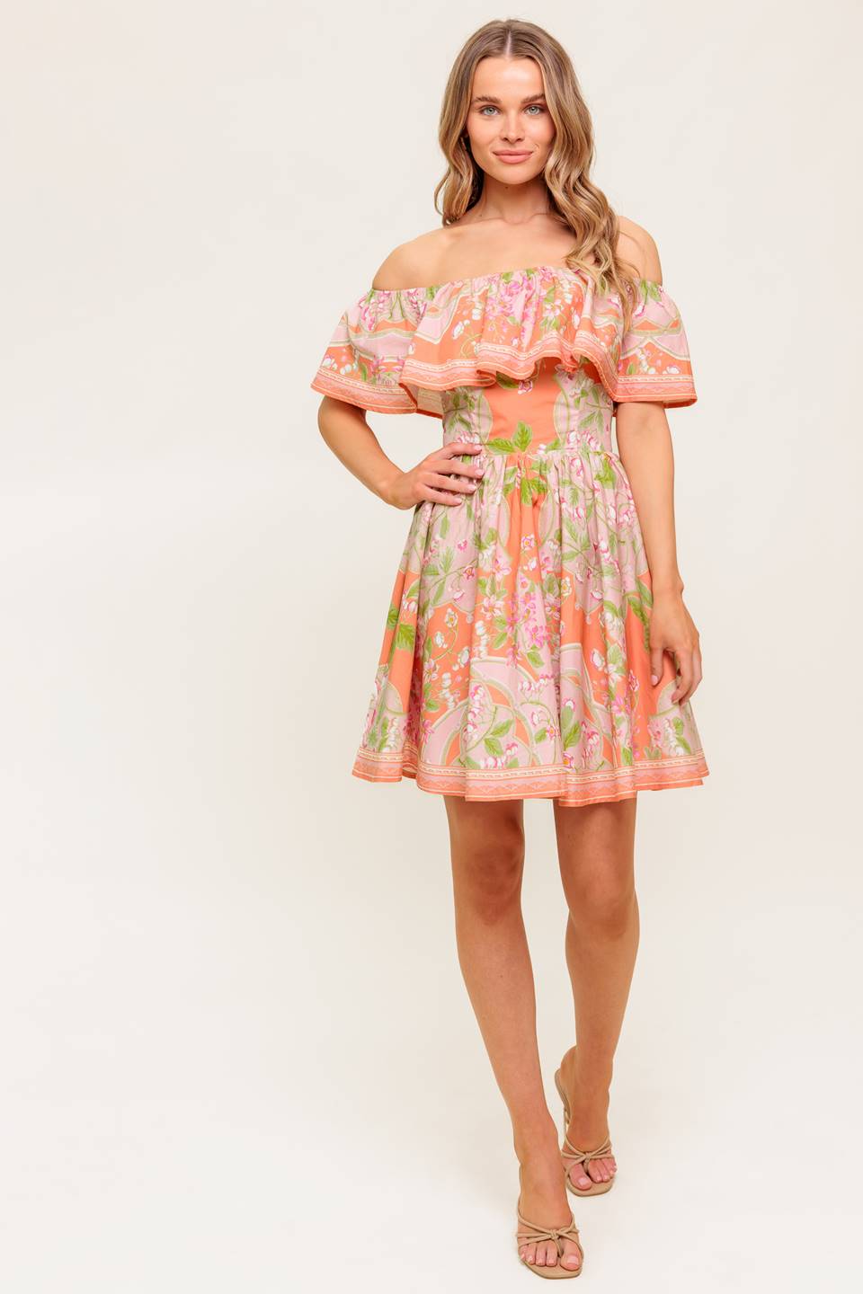 A printed woven mini dress featuring off shoulder neckline with flounce, full skirt and back zipper closure.
