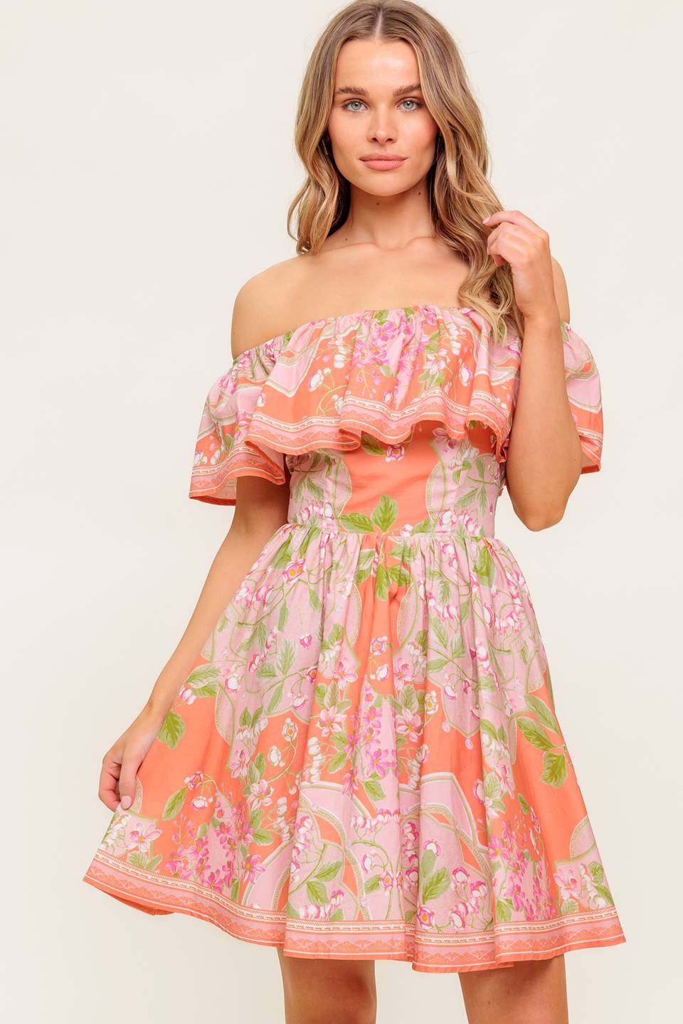 A printed woven mini dress featuring off shoulder neckline with flounce, full skirt and back zipper closure.