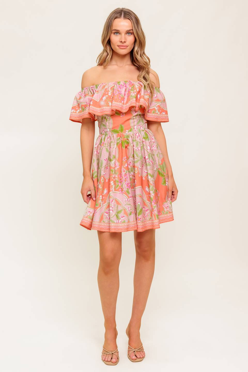 A printed woven mini dress featuring off shoulder neckline with flounce, full skirt and back zipper closure.