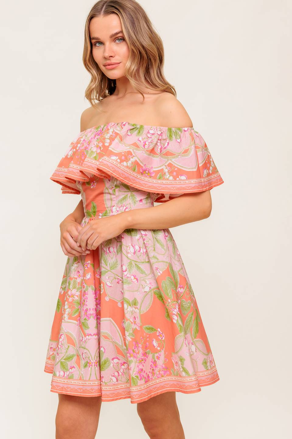 A printed woven mini dress featuring off shoulder neckline with flounce, full skirt and back zipper closure.