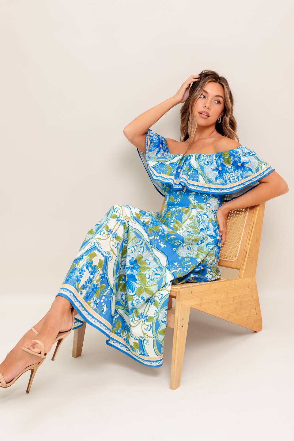 A printed woven midi dress featuring off shoulder neckline with flounce, circle skirt and back zipper closure