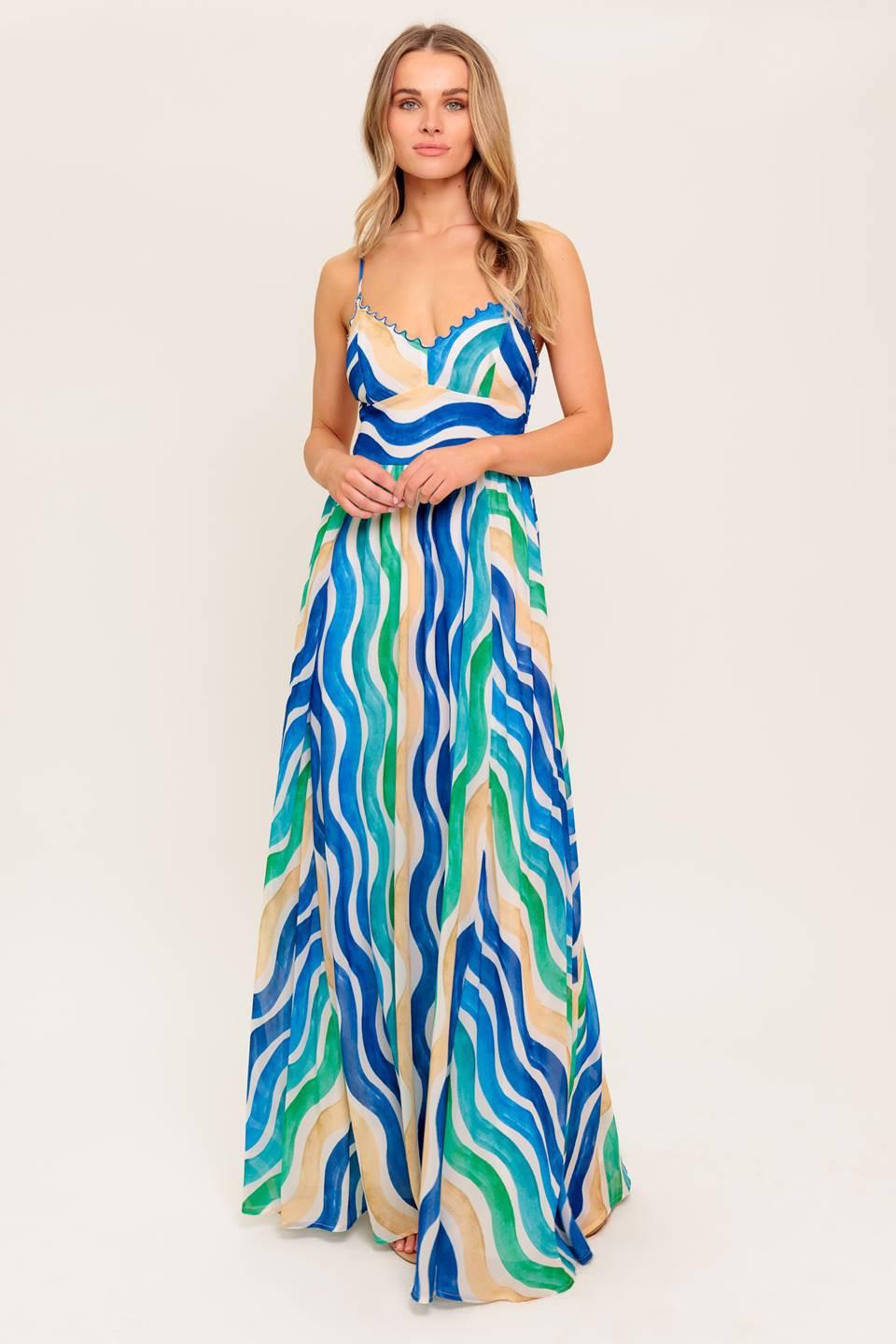 A printed woven maxi dress featuring V neckline with merrow stitch, straps, waist yoke and smocked back bodice.