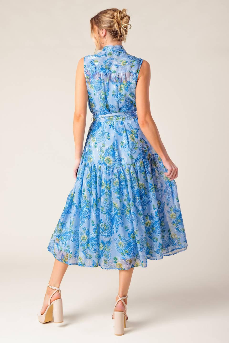 A printed woven midi dress featuring front bow tie, sleeveless, self belt and ruffled hemline