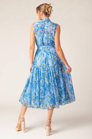 A printed woven midi dress featuring front bow tie, sleeveless, self belt and ruffled hemline