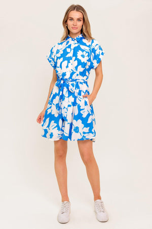 A printed woven mini dress featuring collar, button down, cuffed short sleeve and self sash tie.
