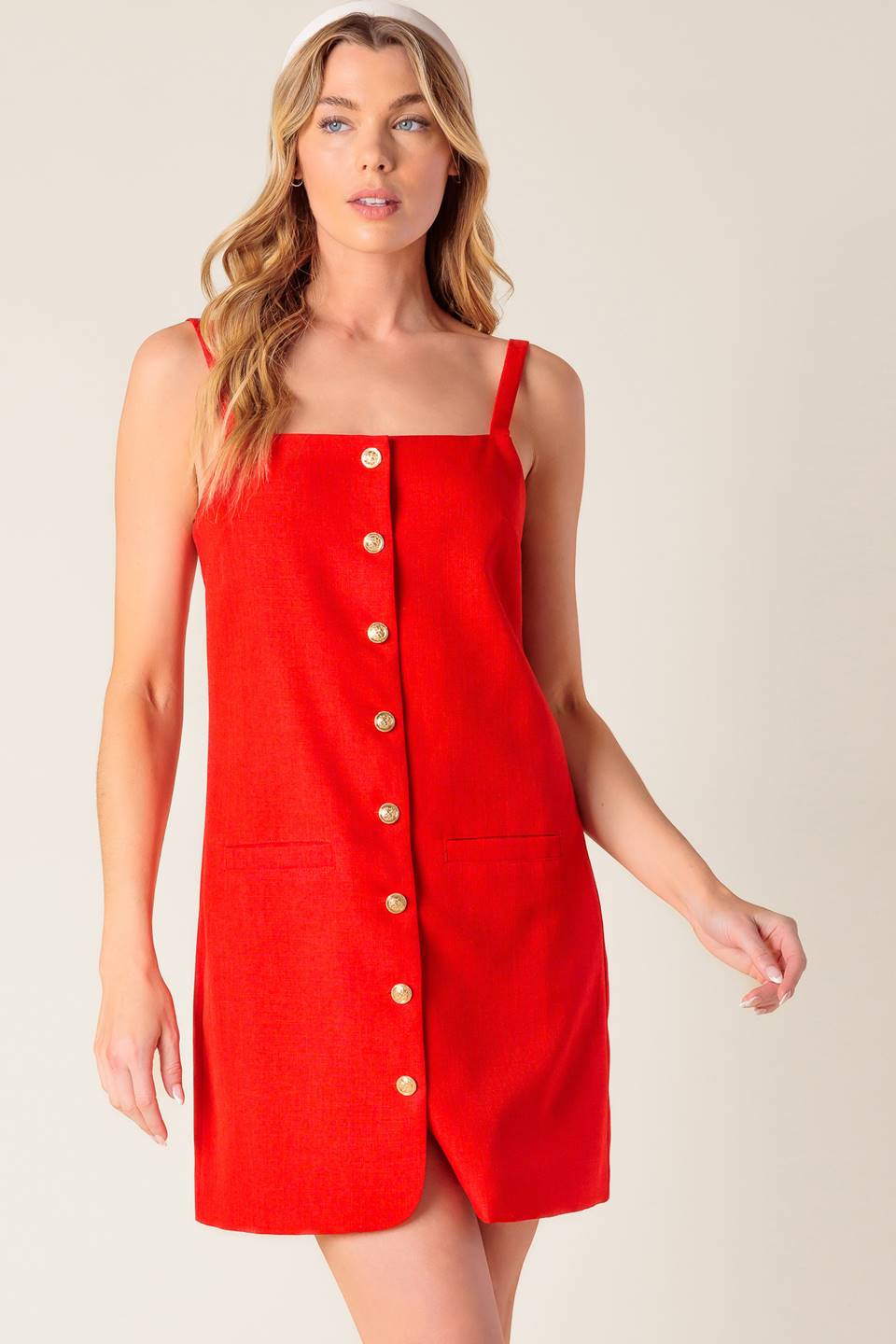 A solid red woven shift dress with front button closure.