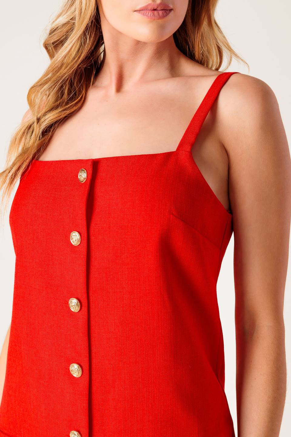 A solid red woven shift dress with front button closure.