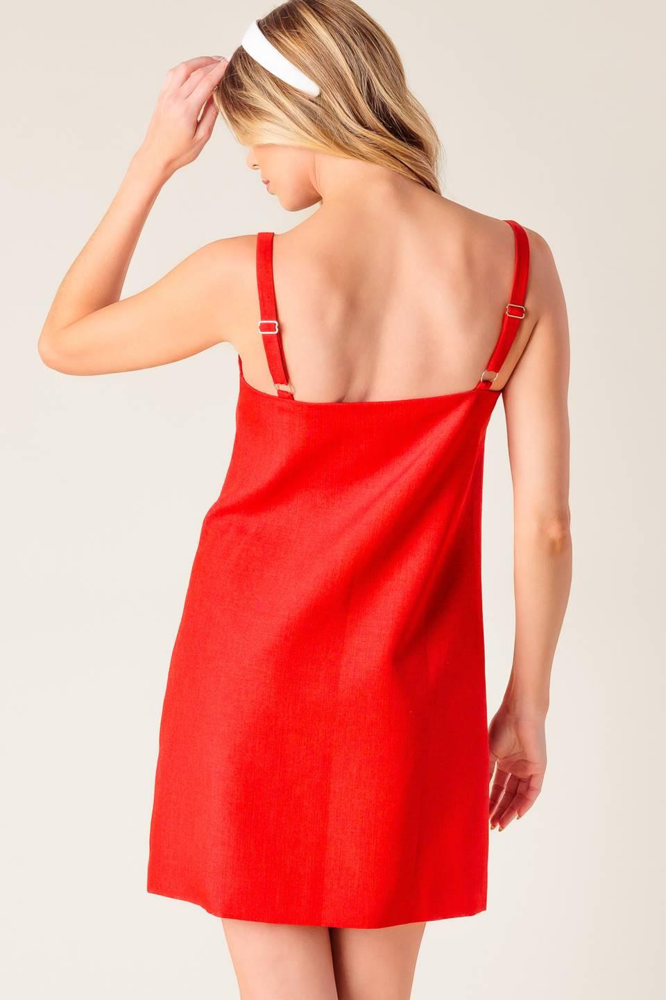 A solid red woven shift dress with front button closure.