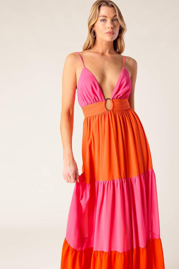 A solid woven color blocked maxi dress featuring cami top with straps, shirred waist band with center hardware, tiered skirt and smocked back waistband