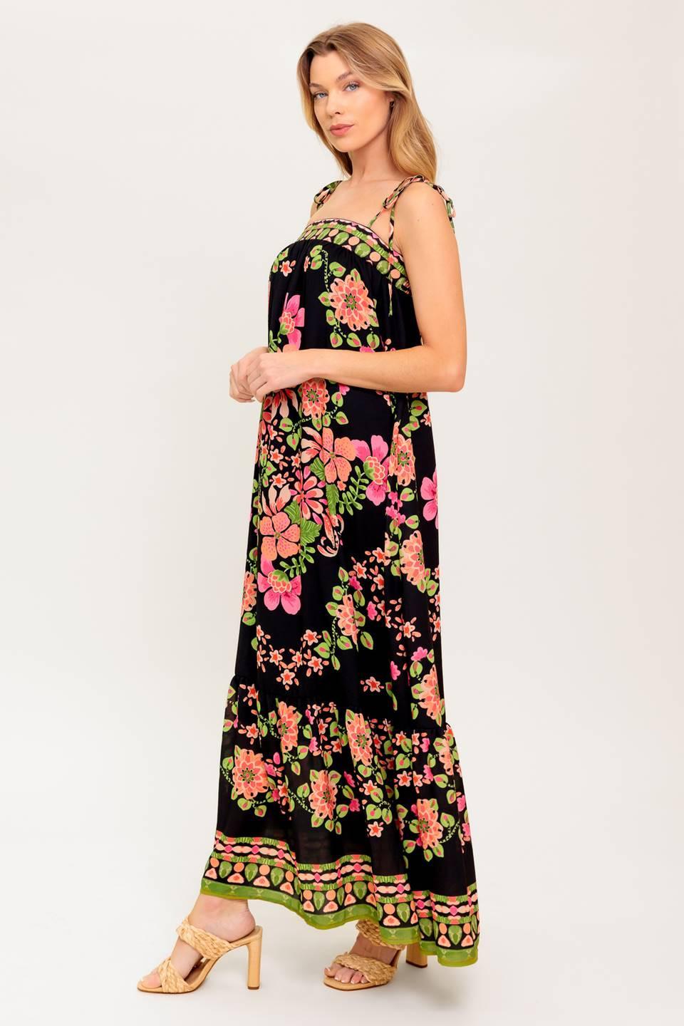 A printed woven maxi dress featuring straight neckline, shoulder tie and ruffled hem