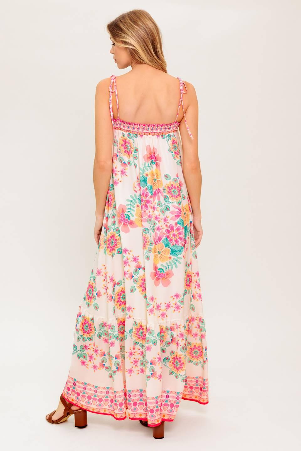 A printed woven maxi dress featuring straight neckline, shoulder tie and ruffled hem