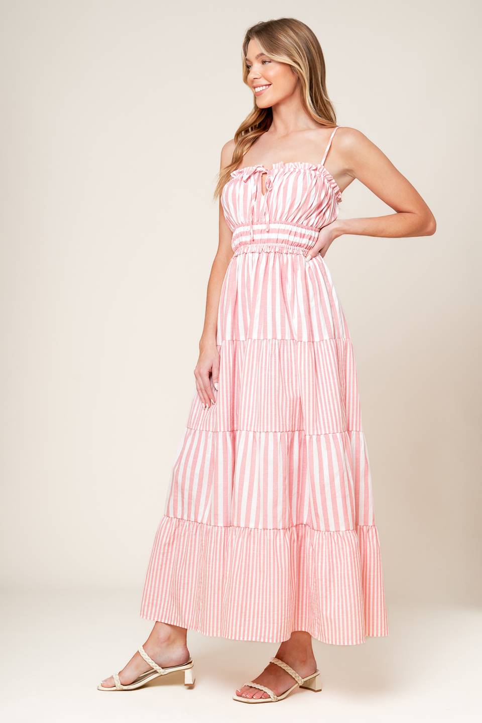 A striped woven maxi dress featuring a straight neckline with ruffled edge and front tie, elasticized waist and tiered skirt.