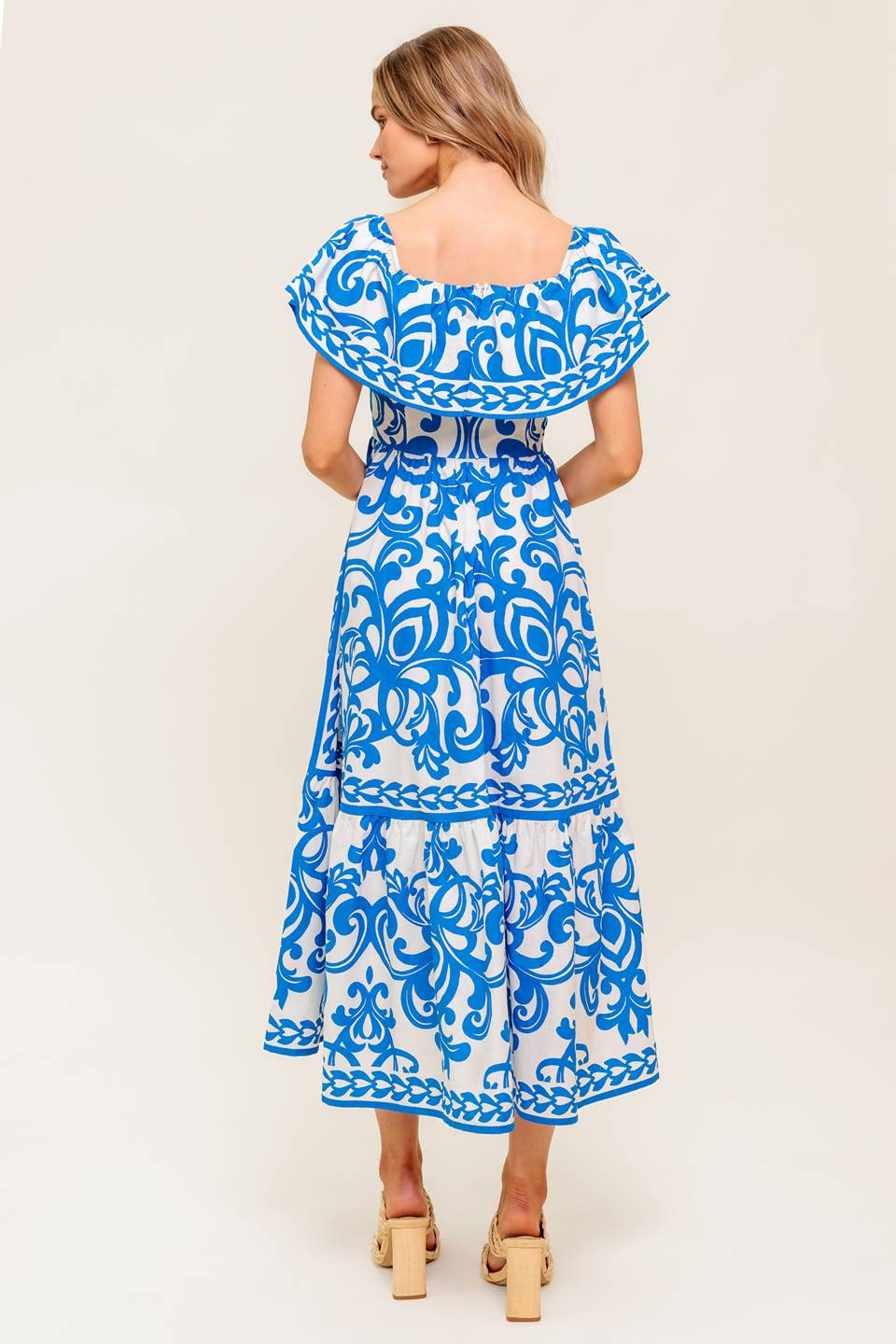 A printed woven midi dress featuring off shoulder neckline with flounce, ruffled hem and back zipper closure