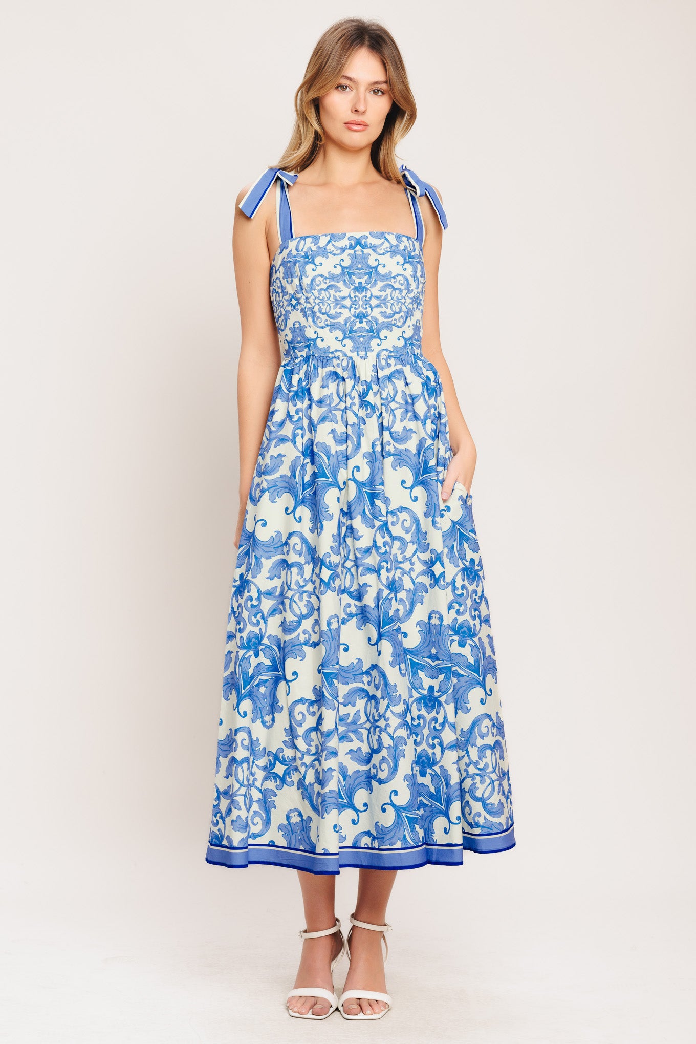 A printed woven midi dress featuring straight neckline, shoulder ties, full skirt and smocked back bodice

Details:

Self: 100% Cotton

Lining: 100% Polyester

Size & Fit

-Model is 5`8" And Wearing Size Small
-Measurements Taken From Size Small
-Approx. Length: 52"
