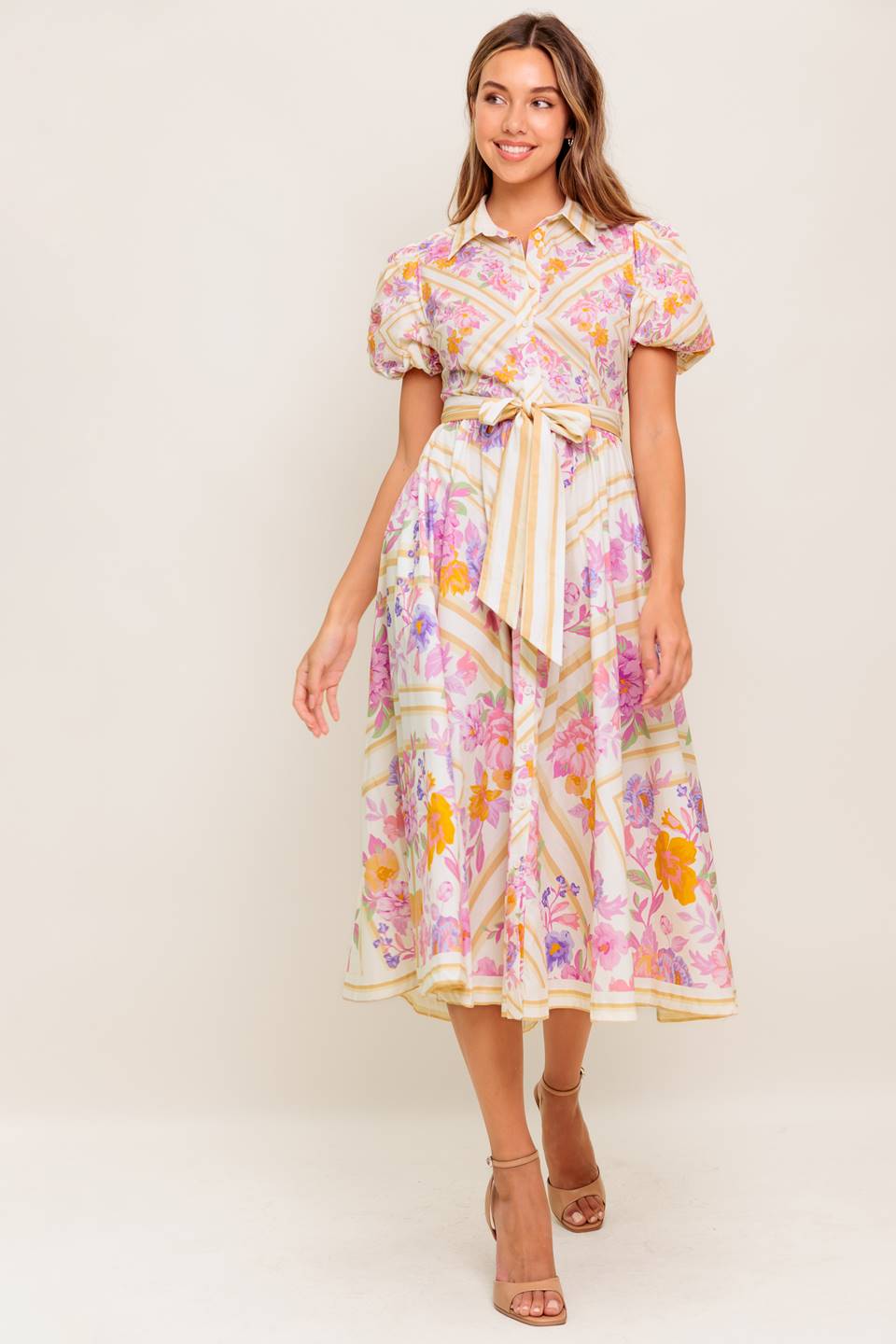 A printed woven midi dress featuring collar, short sleeve, button down, self sash belt and full skirt