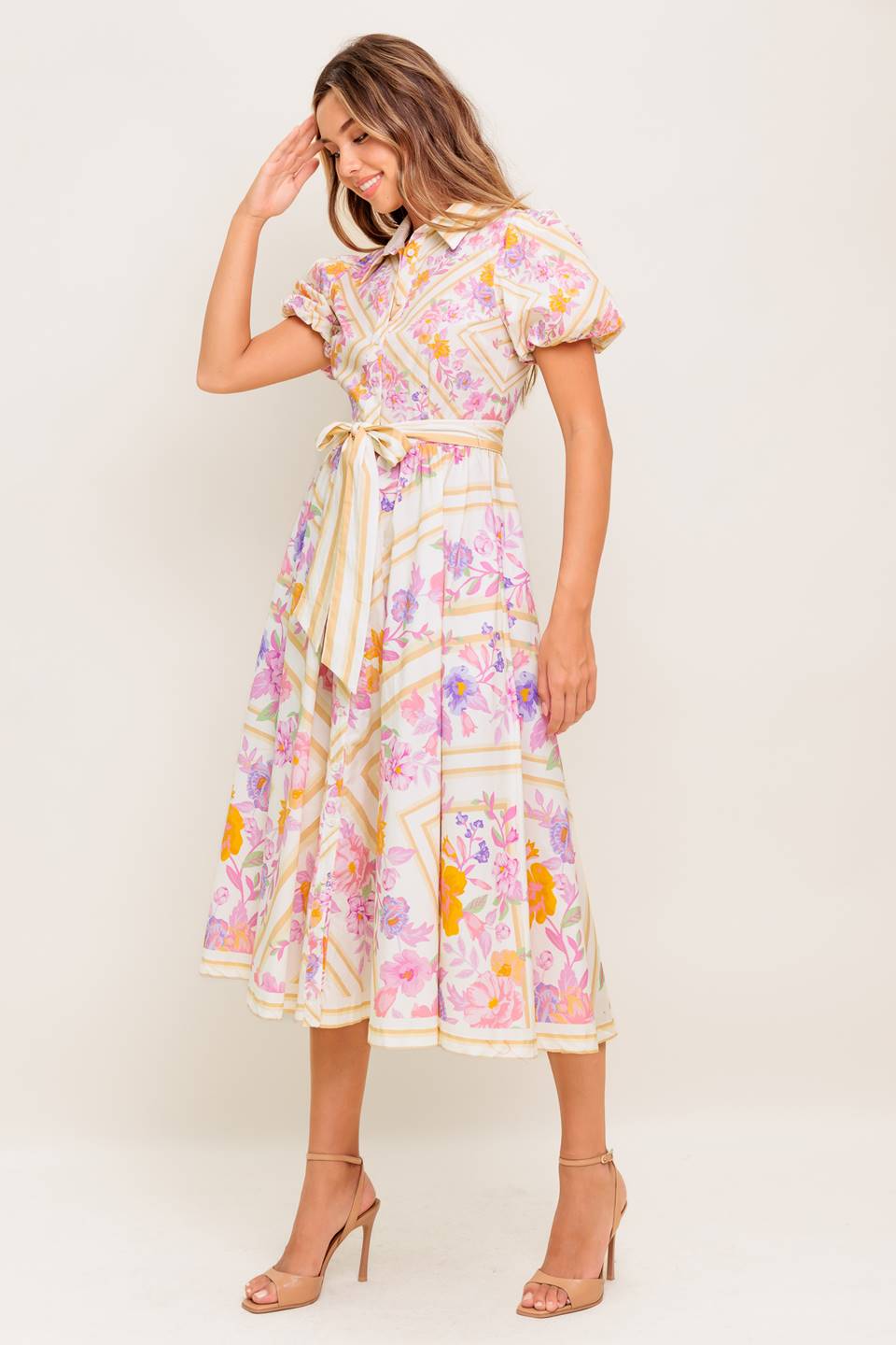 A printed woven midi dress featuring collar, short sleeve, button down, self sash belt and full skirt