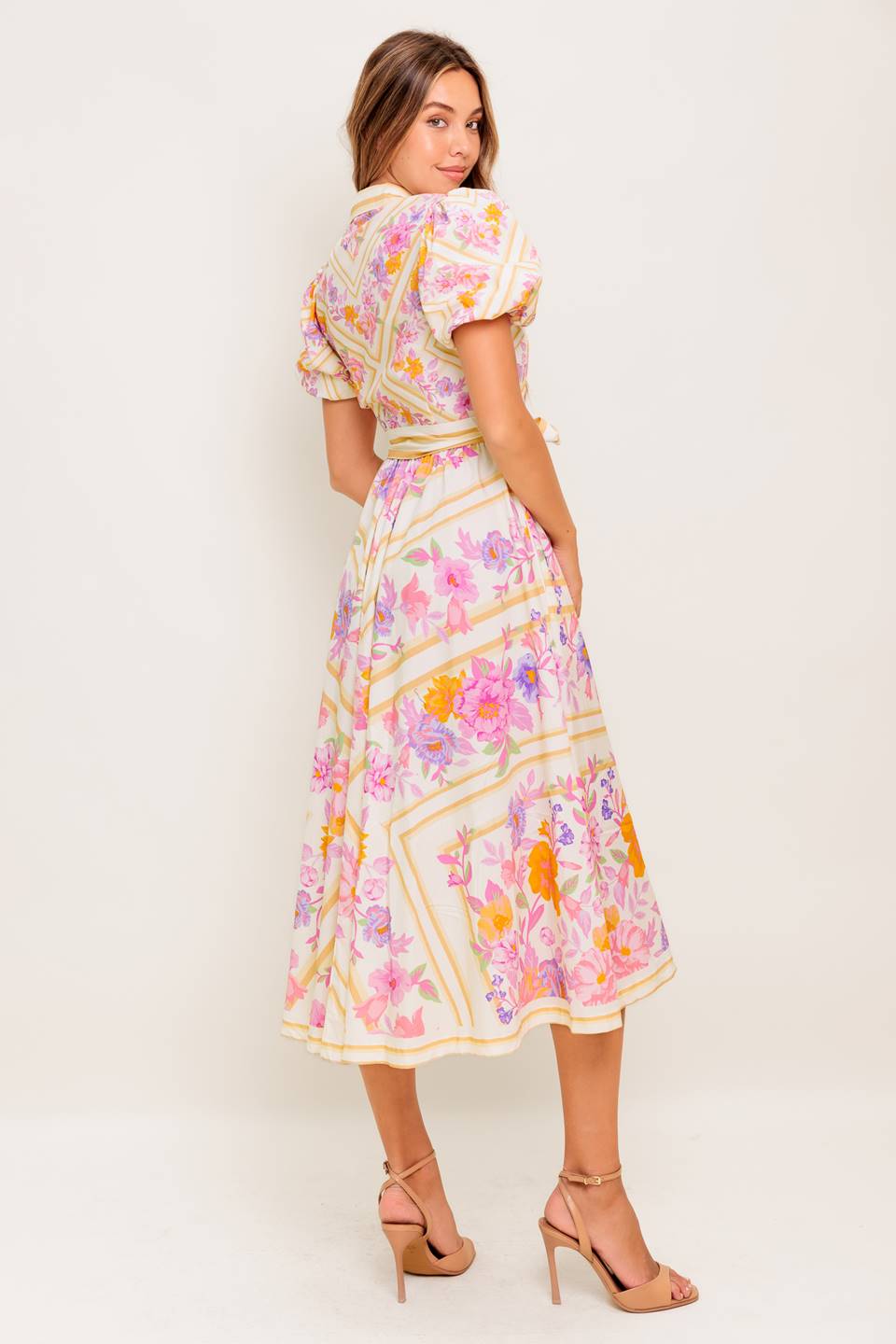 A printed woven midi dress featuring collar, short sleeve, button down, self sash belt and full skirt