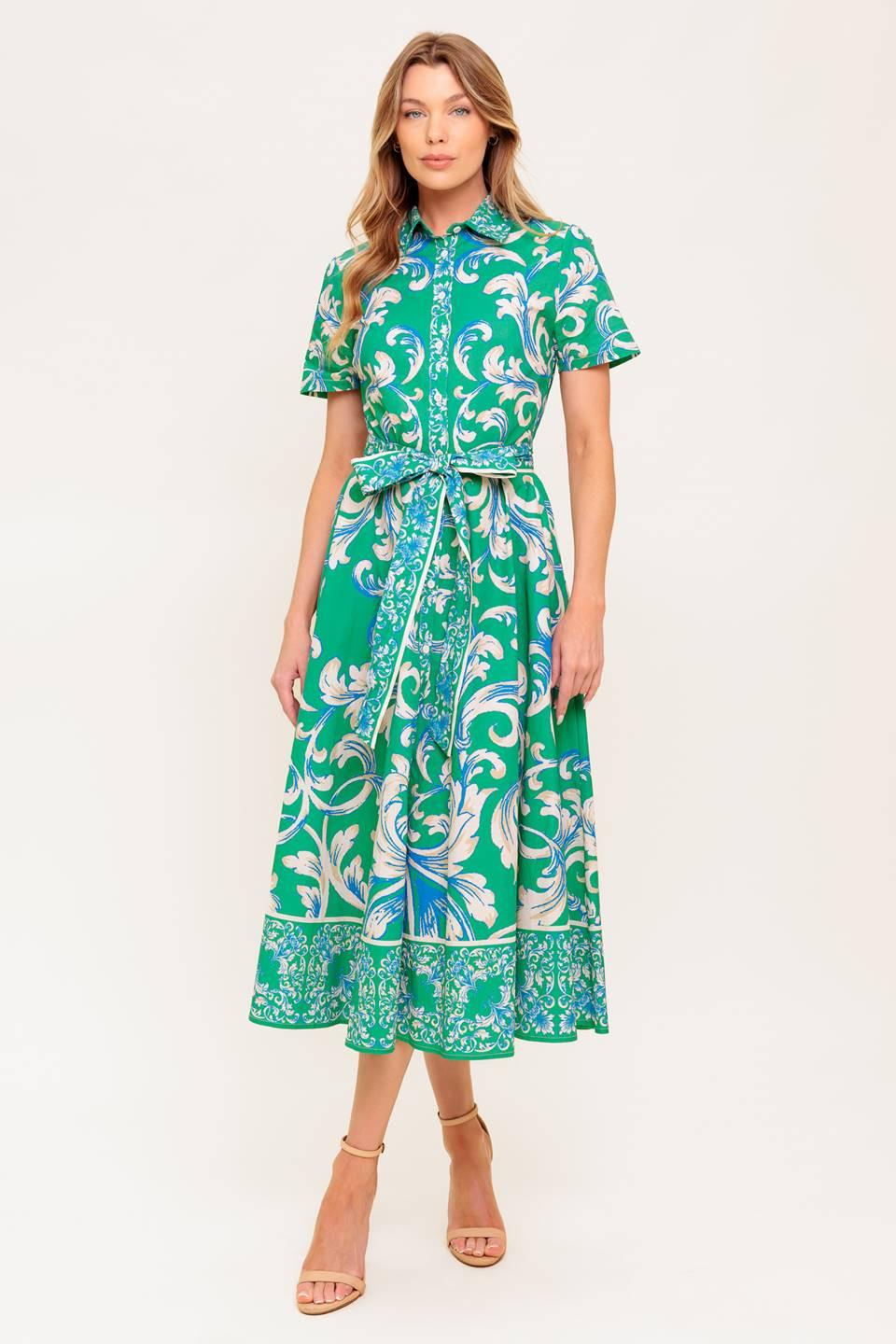 A printed woven midi dress featuring collar, short sleeve, button down, self sash tie and full skirt.