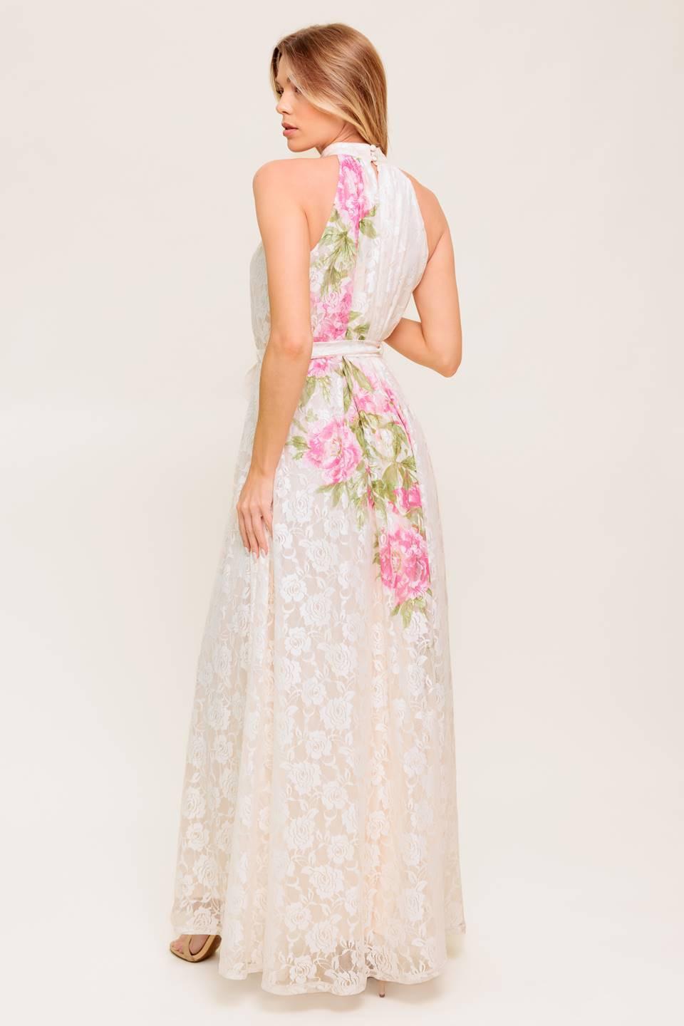 A printed woven lace maxi dress featuring halter neckline, self sash tie and back button closure.