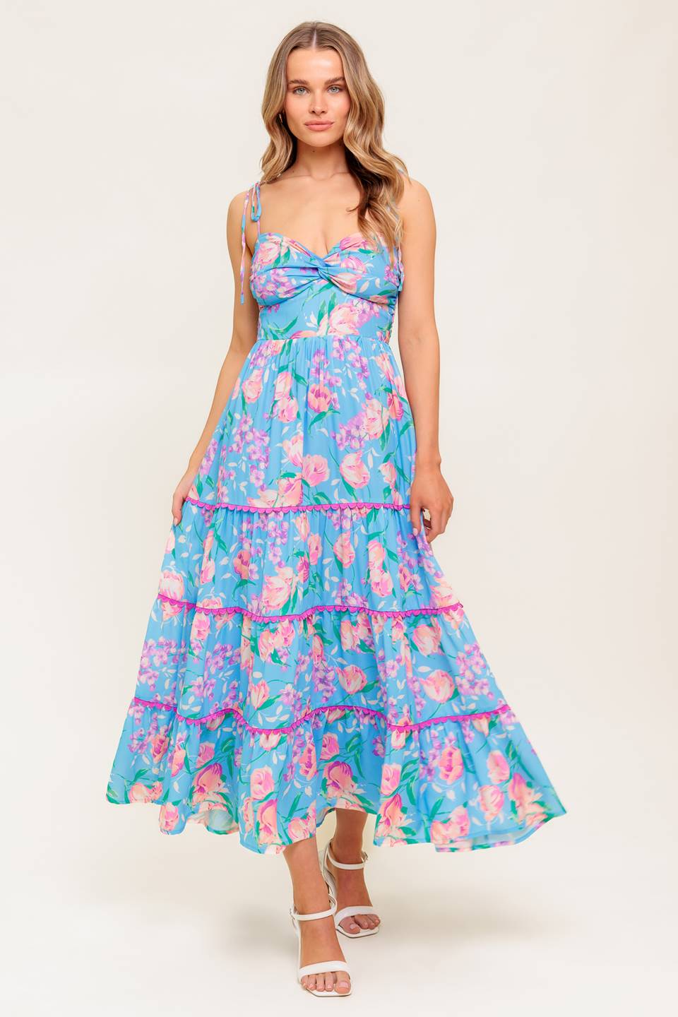 A printed woven midi dress featuring twisted bodice, waist yoke, shoulder ties, tiered skirt with lace edge and smocked back bodice.