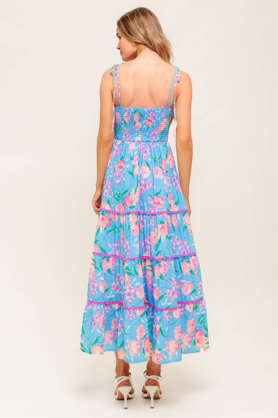 A printed woven midi dress featuring twisted bodice, waist yoke, shoulder ties, tiered skirt with lace edge and smocked back bodice.