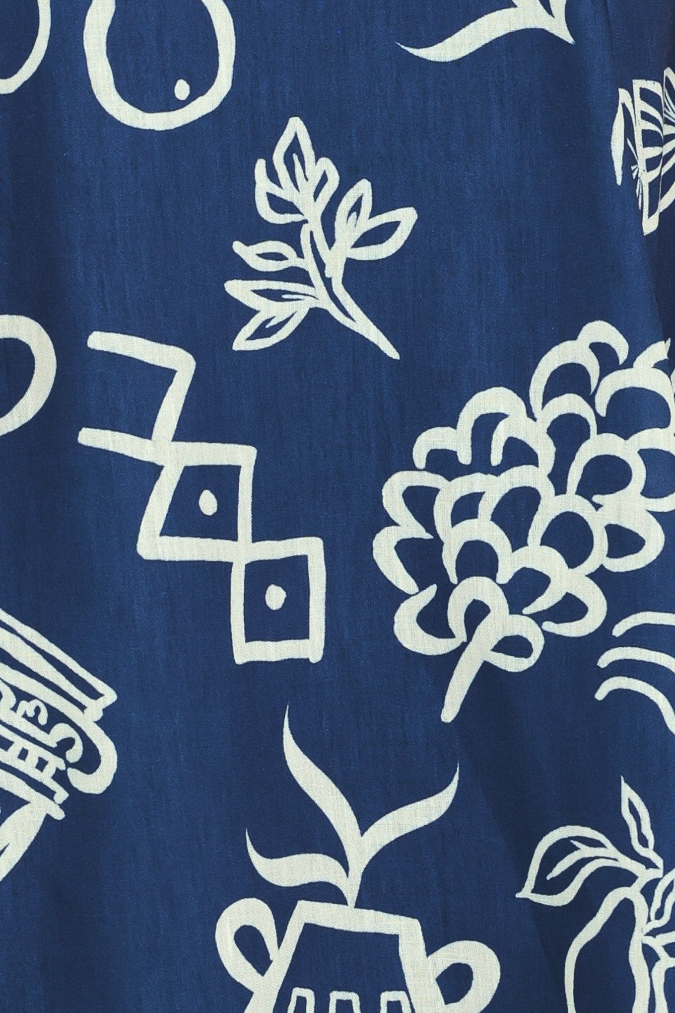 Close up of a navy blue midi dress with fruit and beach elements printed on | Flying Tomato