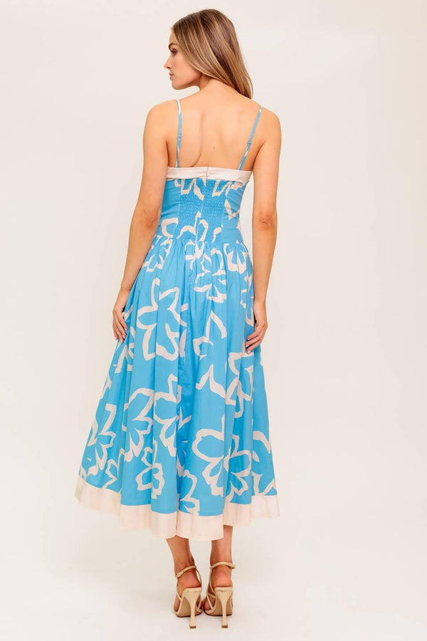 A printed woven midi dress featuring straight neckline, contrasting border and smocked back bodice.