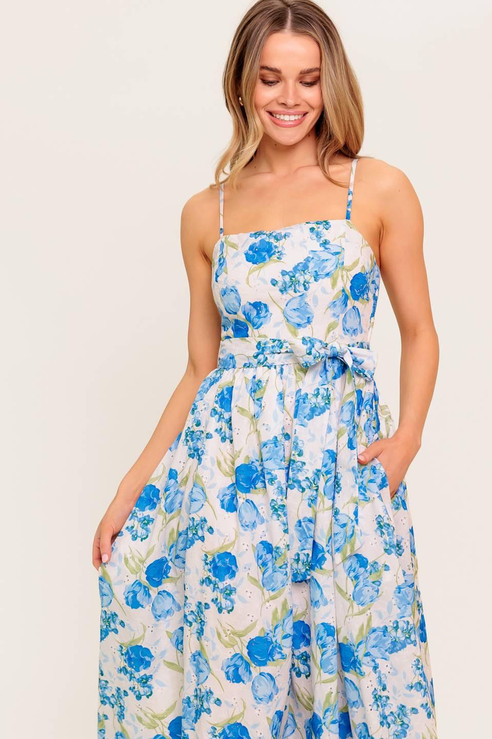 A floral printed woven midi dress featuring straight neckline, straps, self sash tie, full skirt and smocked back bodice.