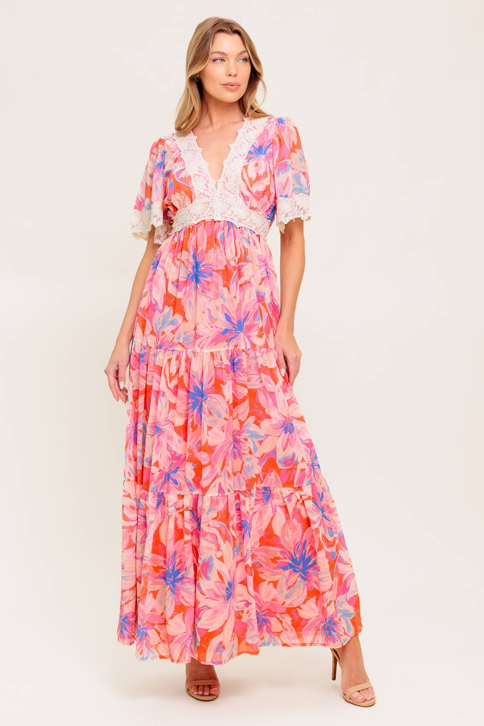 A printed woven maxi dress featuring lace trimmed V neckline, short flutter sleeve with lace hem, lace waistband, tiered skirt and smocked back waistband.
