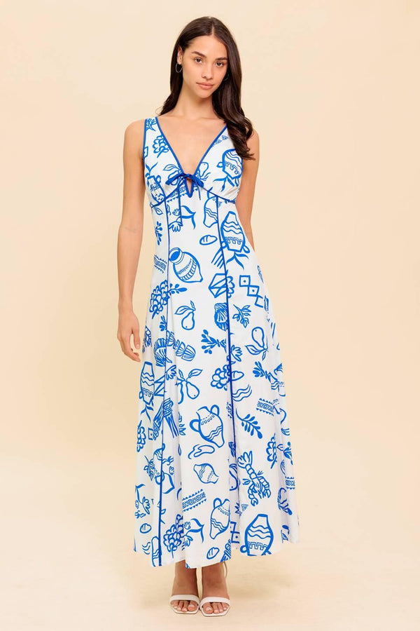 A printed woven ankle dress featuring V neckline with front bow tie, sleeveless, full skirt and plunging V back with zipper closure