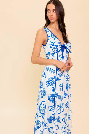 A printed woven ankle dress featuring V neckline with front bow tie, sleeveless, full skirt and plunging V back with zipper closure