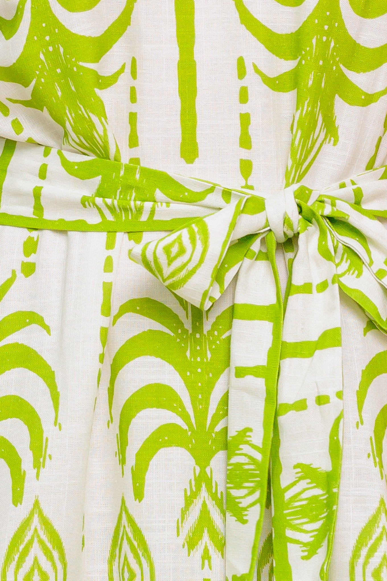 A printed woven mini dress featuring straight neckline, straps, self sash tie and ruffled hemline.