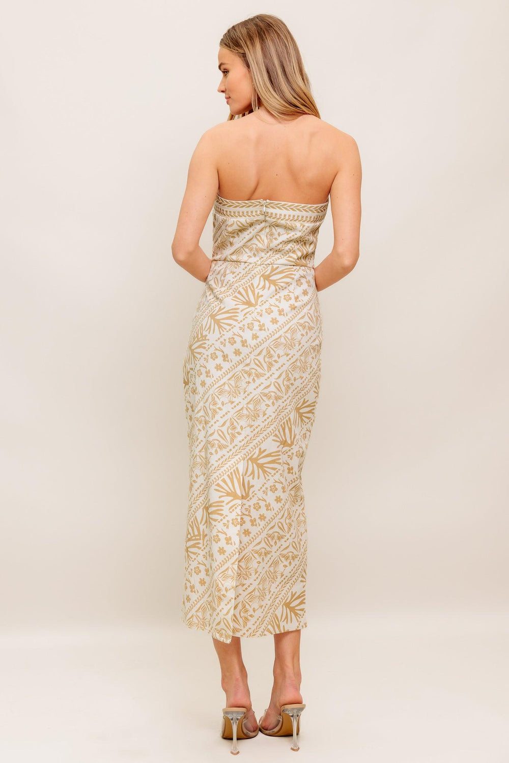 A printed woven midi dress featuring tube top, H line skirt and back zipper closure
