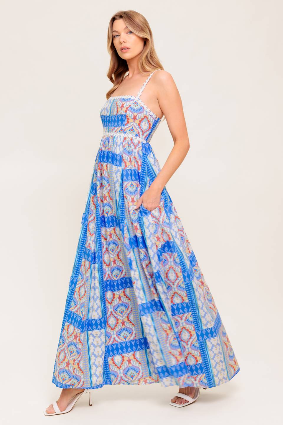 A printed woven maxi dress featuring straight neckline with lace trim, lace shoulder strap, full skirt and smocked back bodice.