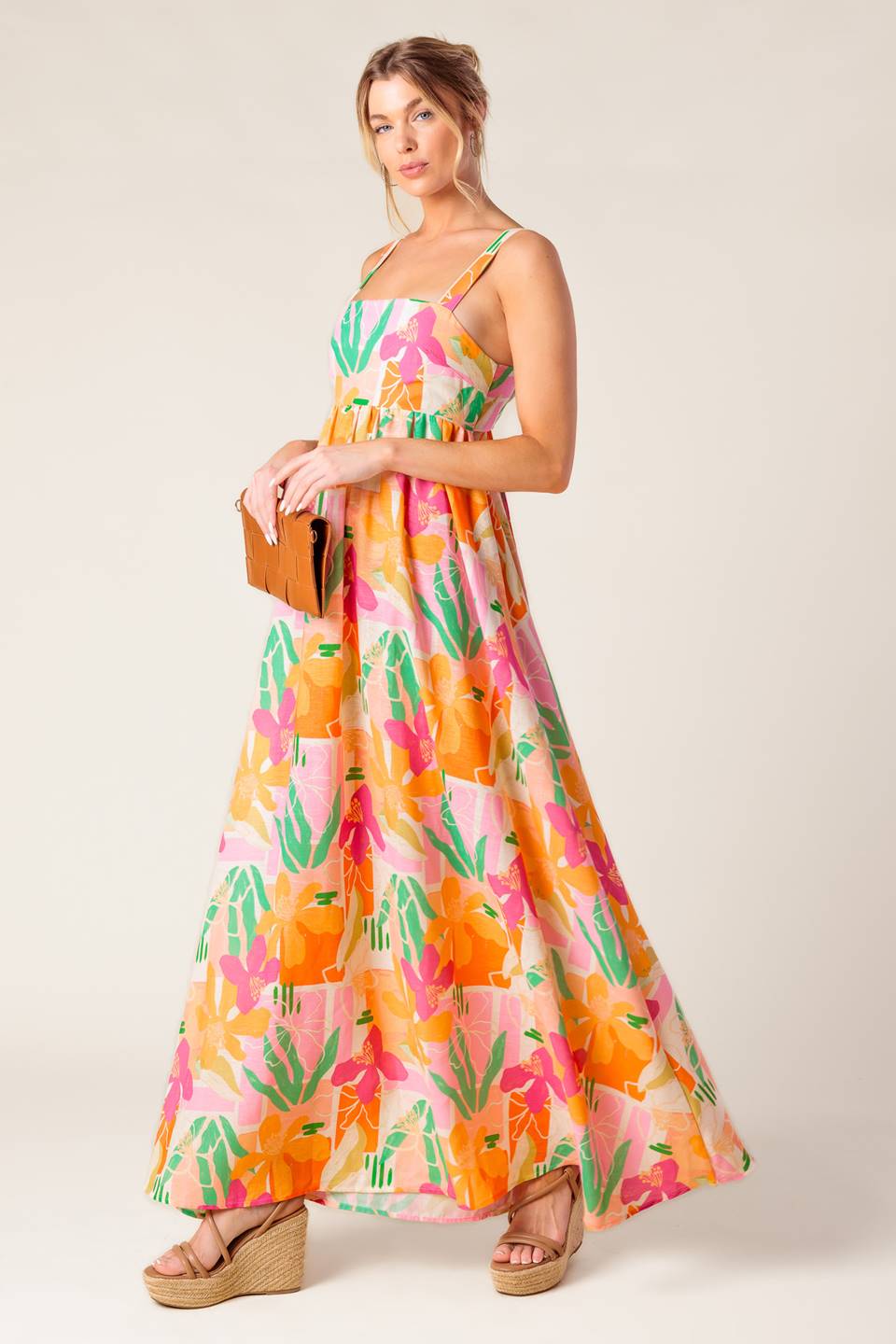 A printed woven maxi dress featuring straight neckline, straps, bare back with tie closure