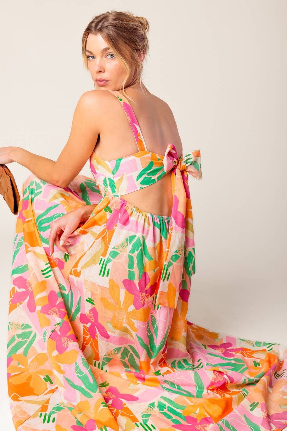 A printed woven maxi dress featuring straight neckline, straps, bare back with tie closure