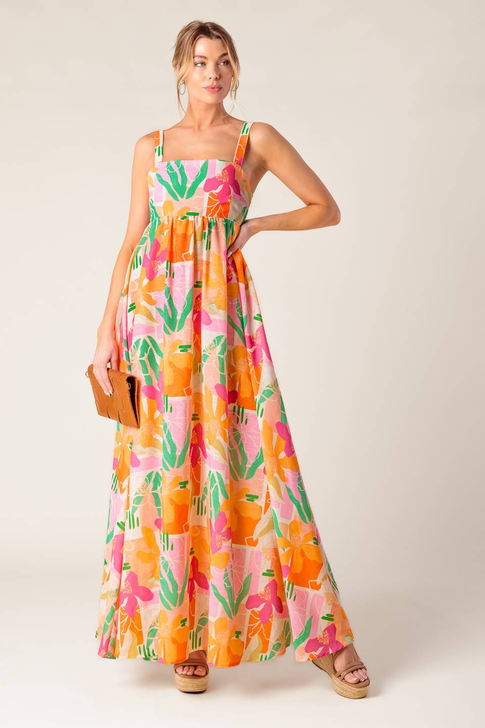 A printed woven maxi dress featuring straight neckline, straps, bare back with tie closure