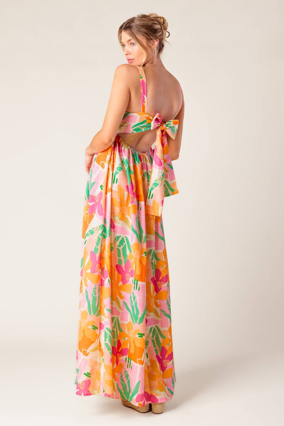 A printed woven maxi dress featuring straight neckline, straps, bare back with tie closure